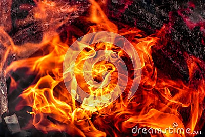 Burning fire close up. Bright orange and red flames on a dark background. Open flame heating. Problems with heating and gas Stock Photo