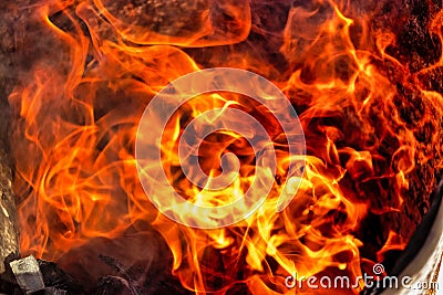 Burning fire close up. Bright orange and red flames on a dark background. Open flame heating. Problems with heating and gas Stock Photo