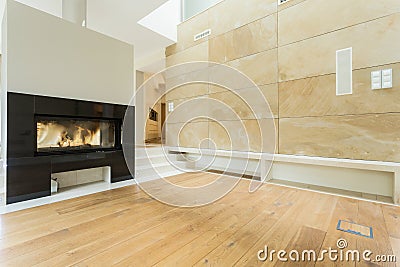 Burning fireplace in beige house Stock Photo