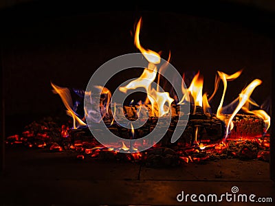 Burning Firewood in Cozy Hearth: Flames Flickering in Rustic Fireplace Stock Photo