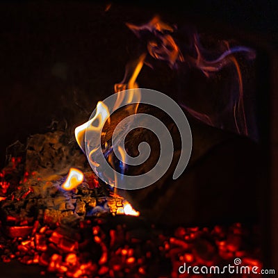 Burning Firewood in Cozy Hearth: Flames Flickering in Rustic Fireplace Stock Photo