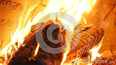 Burning firewood in the fireplace closeup, glowing logs, fire and flames Stock Photo