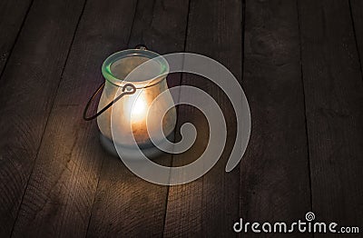 Burning glass lantern at night Stock Photo