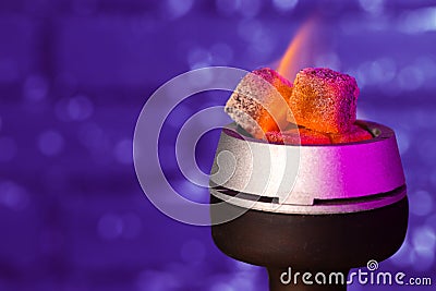 Burning hookah coals in hookah bowl close up Stock Photo