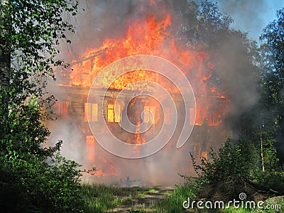 Burning house. Big wooden building completely destroyed by fire Stock Photo