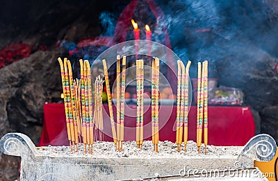 Burning incense and worship the gods in the buddhist temple in Qingyan Ancient Town, Guizhou province, China. The old town is a Editorial Stock Photo