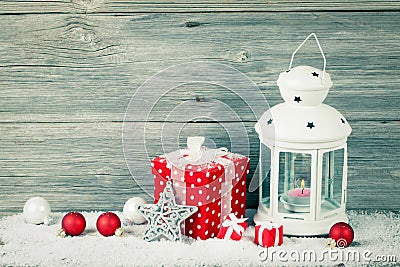 Burning lantern in the snow with christmas decoration Stock Photo