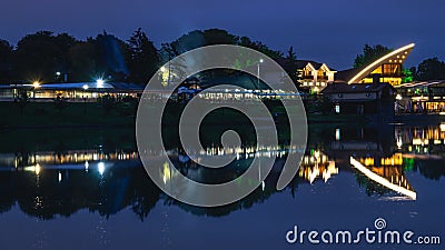 Burning lights of night establishments near the lake Stock Photo