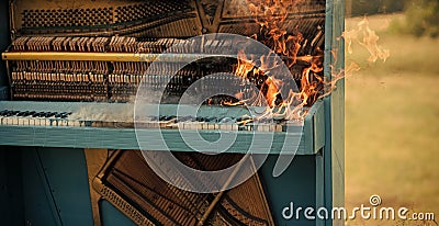 Burning piano, musical style, grunge instrument. Rock concert, jazz, fireplace, destruction. Stock Photo