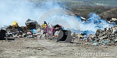 Burning pile of garbage, cause of air pollution. Pollution concept. Rubbish Editorial Stock Photo