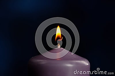 Burning purple candle close-up Stock Photo