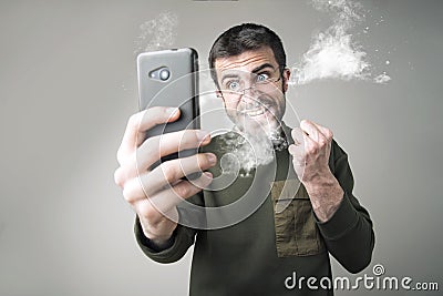 Burning with rage with his phone Stock Photo