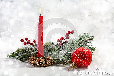 Burning red candle with snow fir branches. Christmas advent Stock Photo