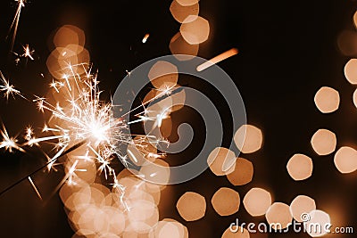 Burning sparklers on dark bokeh background , Happy New Year Stock Photo