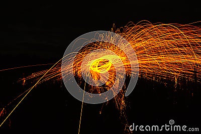 Burning steel wool spinned in the forest. Showers of glowing spa Stock Photo