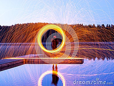 Burning steel wool spinning, showers of glowing sparks from spinning steel wool Stock Photo