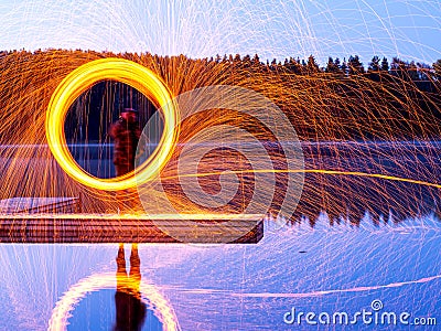 Burning steel wool spinning, showers of glowing sparks from spinning steel wool Stock Photo