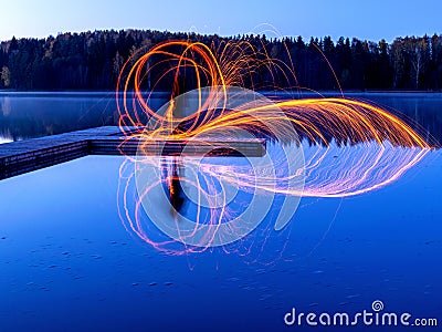 Burning steel wool spinning, showers of glowing sparks from spinning steel wool Stock Photo