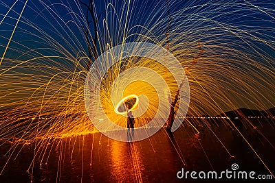 Burning Steel Wool spinning at sunset Stock Photo