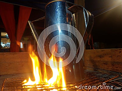 Burning tea pot for a ginger drinks called wedang jahe Stock Photo