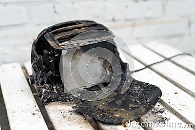 Burning toaster. Toaster with two slices of toast caught on fire over white background Stock Photo