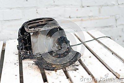 Burning toaster. Toaster with two slices of toast caught on fire over white background Stock Photo