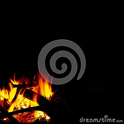 Burning wood at night, flame and fire sparks on dark abstract background, photo leaving place for imagination and meditations Stock Photo