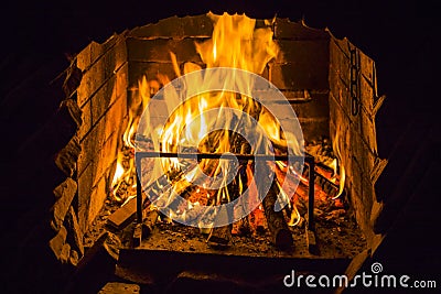 Burning wood in open fire place. Red flames in the fireplace Stock Photo