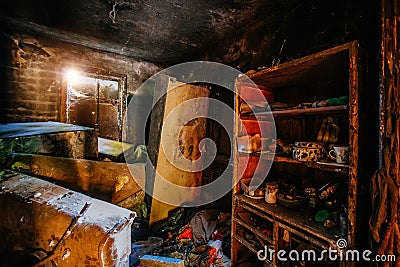 Burnt apartment house interior. Burned furniture and charred walls in black soot Stock Photo