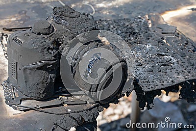 Burnt, broken SLR digital camera. insured property. non-warranty case. consequences of fire. insurance case Stock Photo