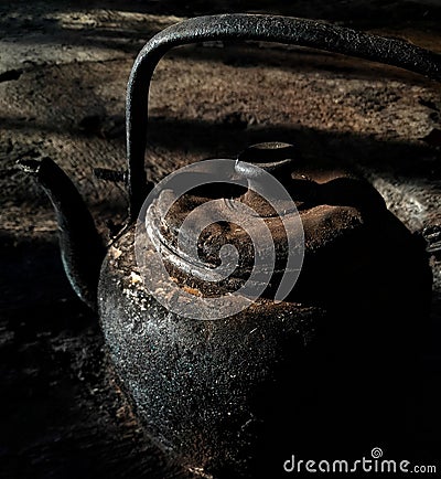 a burnt and dirty iron teapot Stock Photo