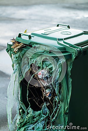 Burnt green garbage can Stock Photo
