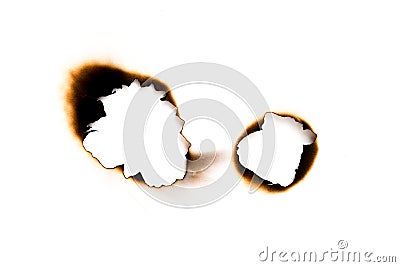 burnt holes in a piece of paper isolated on white background Stock Photo