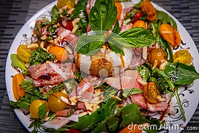 Burrata on top of a salad with cantalope Stock Photo