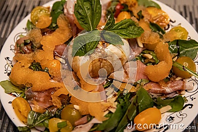 Burrata on top of a salad with cantalope Stock Photo