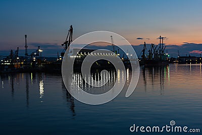 Burrgas Sea Port at night. Silhouettes of cranes and reflections in the water Stock Photo