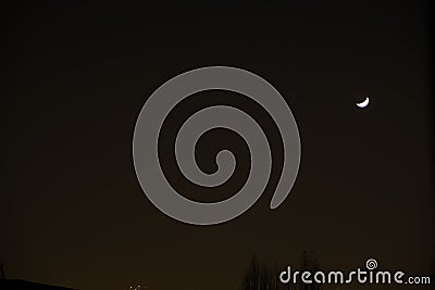 Bursa sky during foggy night. Crescent moon and trees. Stock Photo