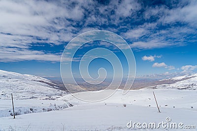 Burst of Clouds and Valleys Covered In Snow with Overlooking Plateau Stock Photo