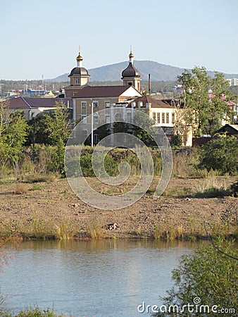 Buryatia, Ulan-Ude, Uda river, buildings and hills in the distance. Stock Photo