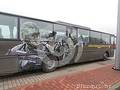 A bus with Baltic numbers parked in Poland. In the picture, the soldiers do not have a Russian emblem on the sleeve of one of them Editorial Stock Photo