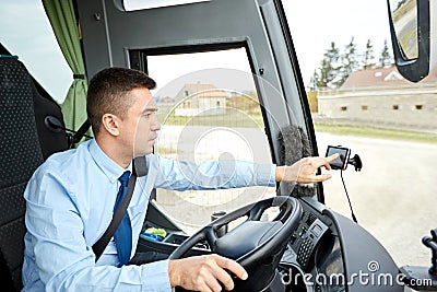 Bus driver entering address to gps navigator Stock Photo