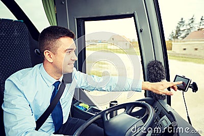 Bus driver entering address to gps navigator Stock Photo