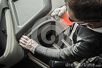 Bus Driver Sanitizing Railings Using Alcohol in Spray Stock Photo
