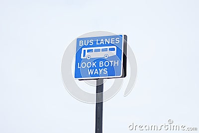 Bus lanes look both ways blue sign post bus icon in sky large space at airport Stock Photo