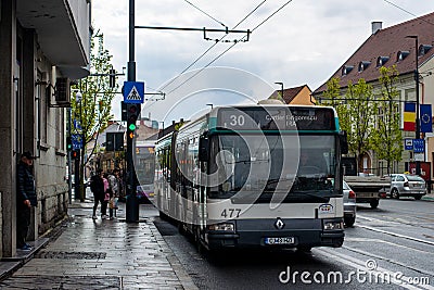 CLUJ-NAPOKA, ROMANIA - April 27, 2022. Bus Renault Agore L #477 riding with passengers in the streets of Cluj-Napoka. Editorial Stock Photo
