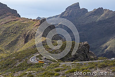 Bus runs along a mountain road Stock Photo