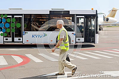 Bus and unidentified airport worker. Igor Sikorsky Kyiv International Airport Zhuliany Editorial Stock Photo