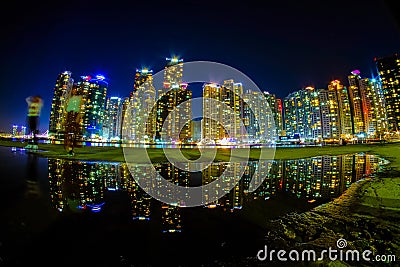 Busan cityscape at nighttime with reflection at Haeundae beach Editorial Stock Photo