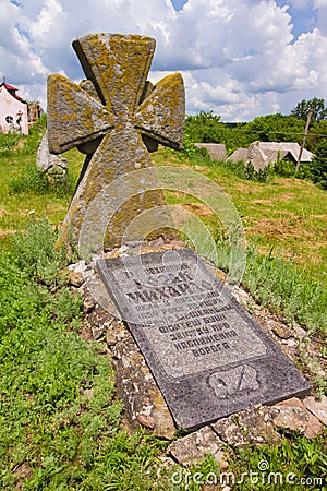 Monument and tombstone in a yard of ruined castle to a warrior hero of Bohdan Khmelnytsky rebellion Editorial Stock Photo