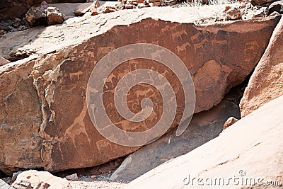 Bushmen petroglyphs at Twyfelfontein. Design with giraffe, lion, horses and other animals. Namibia Stock Photo